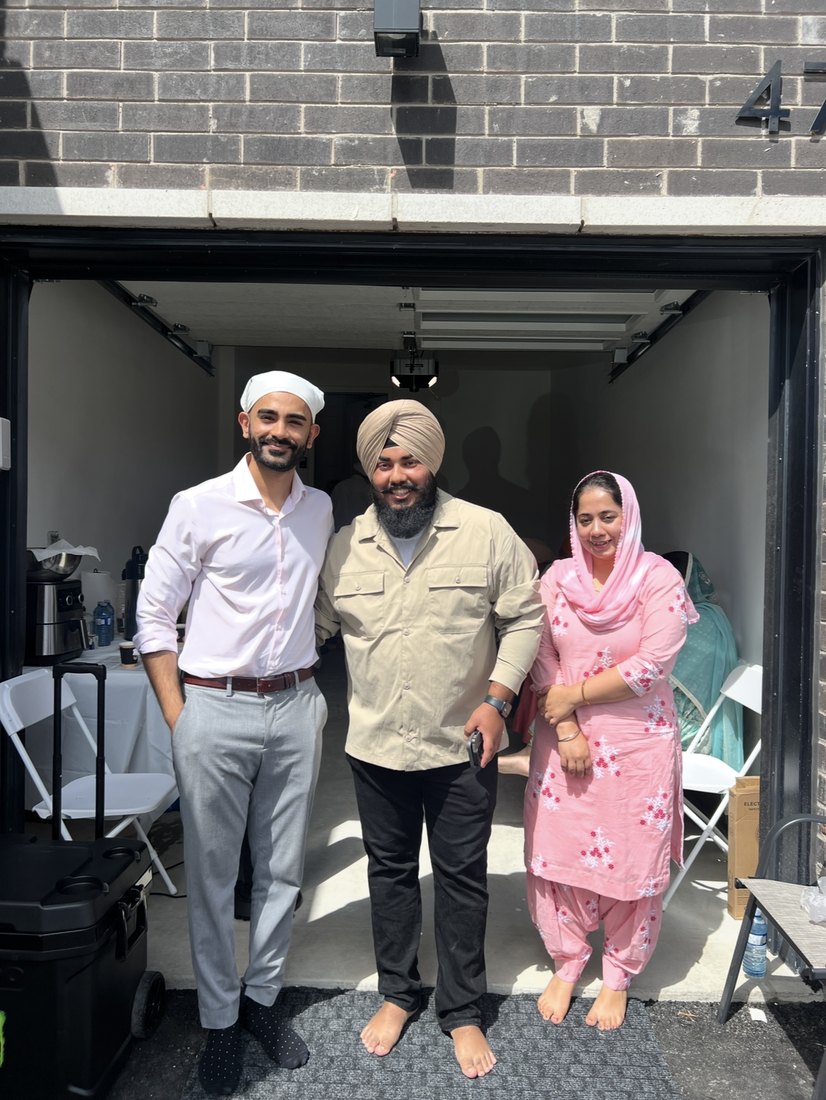 Hammad Mahmud with happy home buyers at their new build home